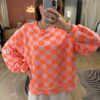 Pull damier orange et parme